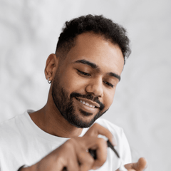 A man applying our Growth Activator serum